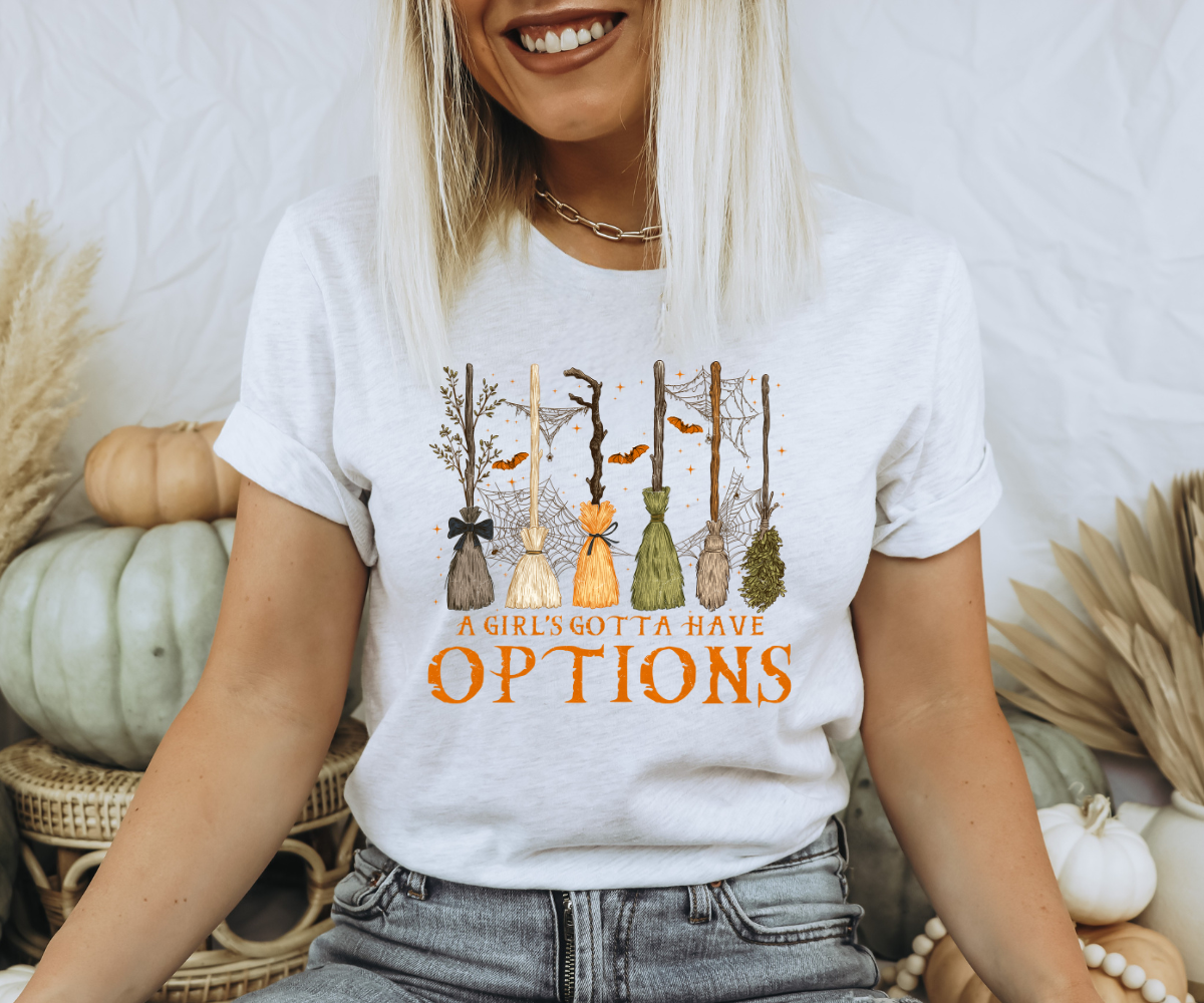 A Girl’s Gotta Have Options Broomstick Tee
