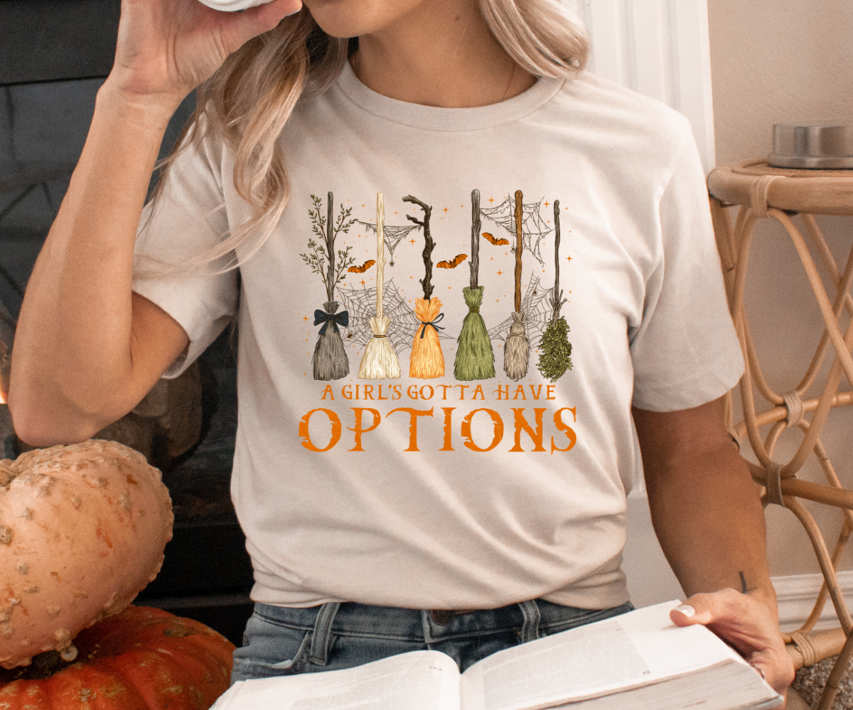 A Girl’s Gotta Have Options Broomstick Tee